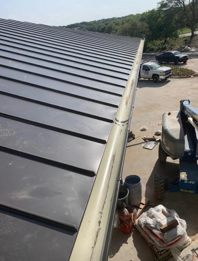 Standing seam panel and gutter detail on a metal roofing jobsite in Lynchburg